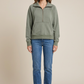 Full-body model view of sage pullover with jeans and ankle boots